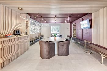 A dining room with a table and a tv